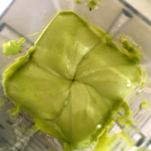 Avocado mayo forms four squares as it is moving around the blades of the Vitamix.
